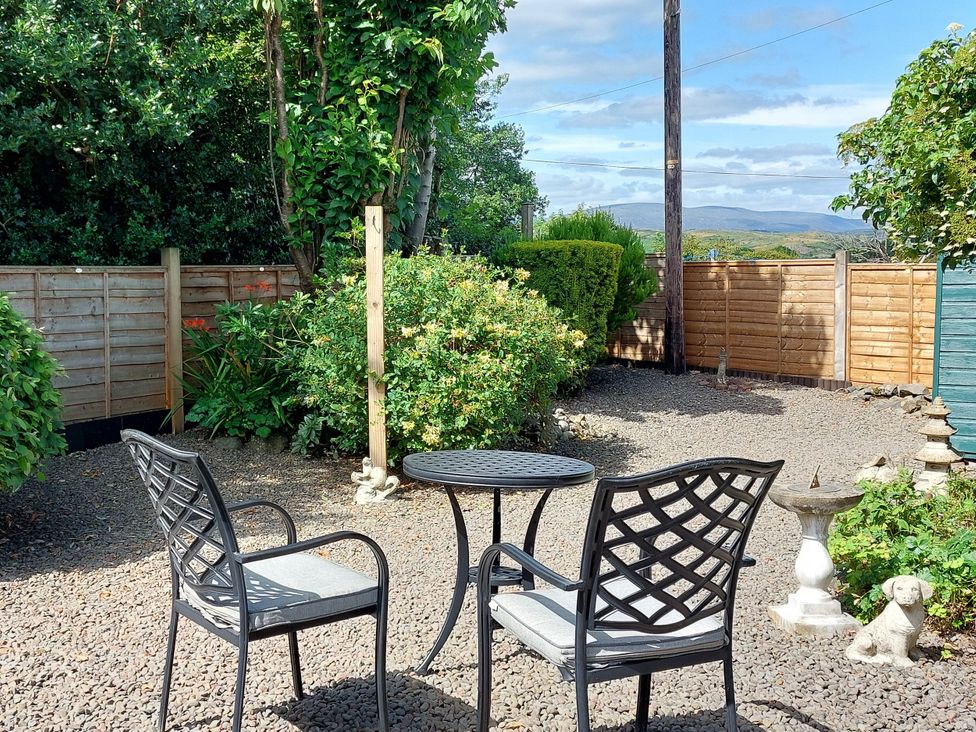 A garden with a table and chairs at Edge Hill St. John's Town Of Dalry