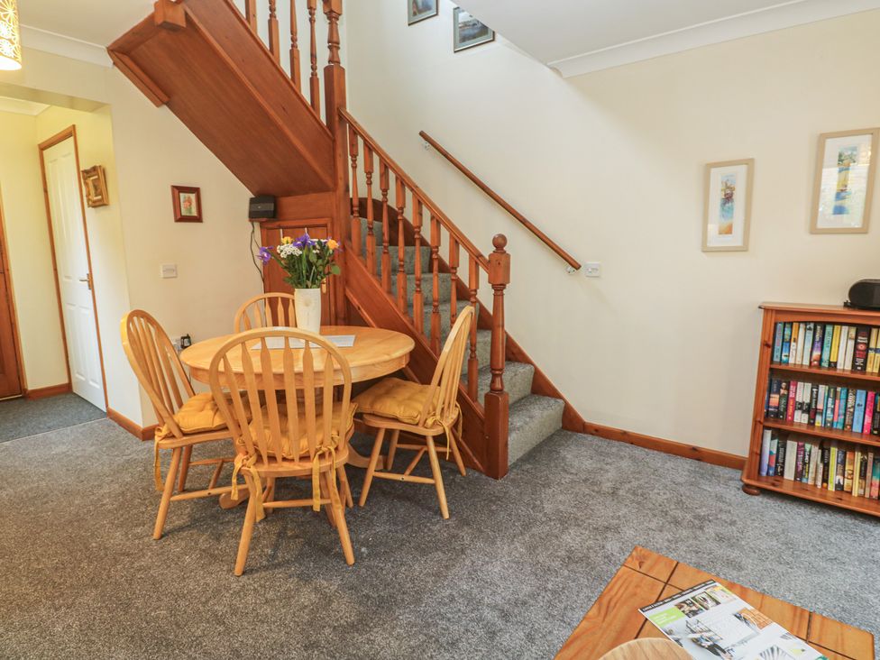 A dining room featuring a table and chairs at Two Hoots in Falmouth