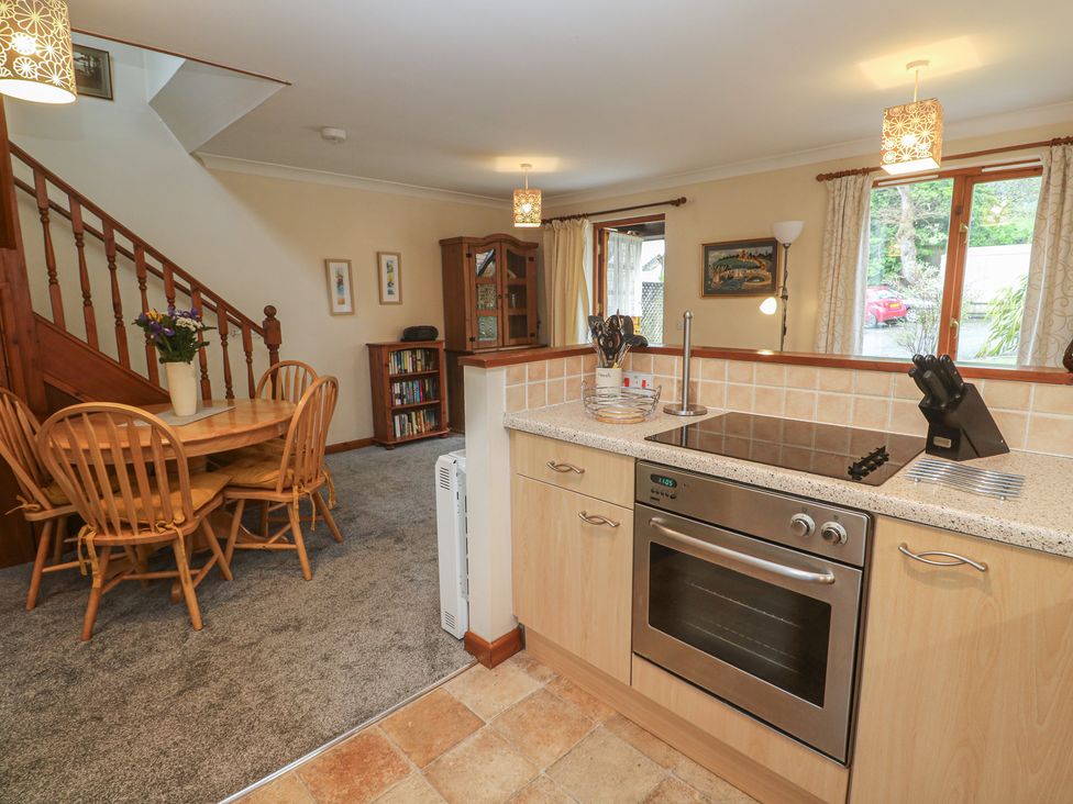 A kitchen with dining table and chairs at Two Hoots in Falmouth