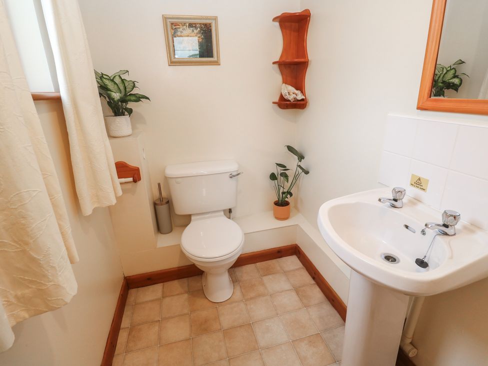 A bathroom with a toilet and sink at Two Hoots in Falmouth