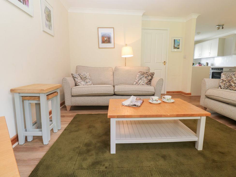 A living room with a sofa and coffee table at Sild Cottage in Falmouth
