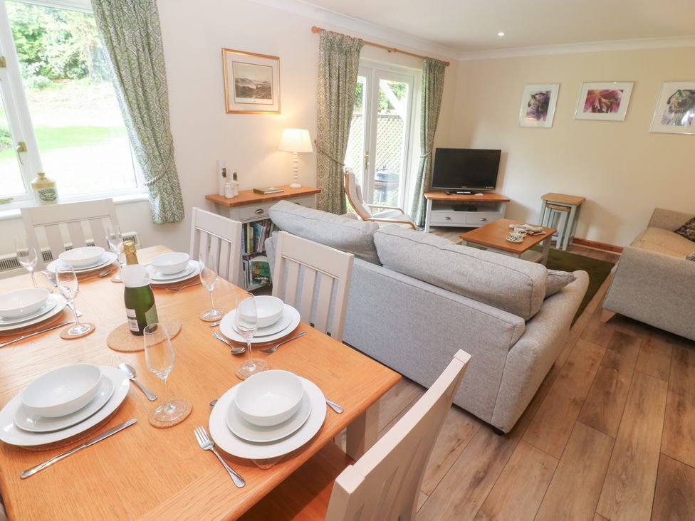 A living room with a dining set and sofa at Sild Cottage in Falmouth