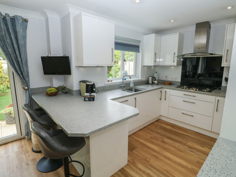 A kitchen with a sink and stove at Glebe House in Bigbury