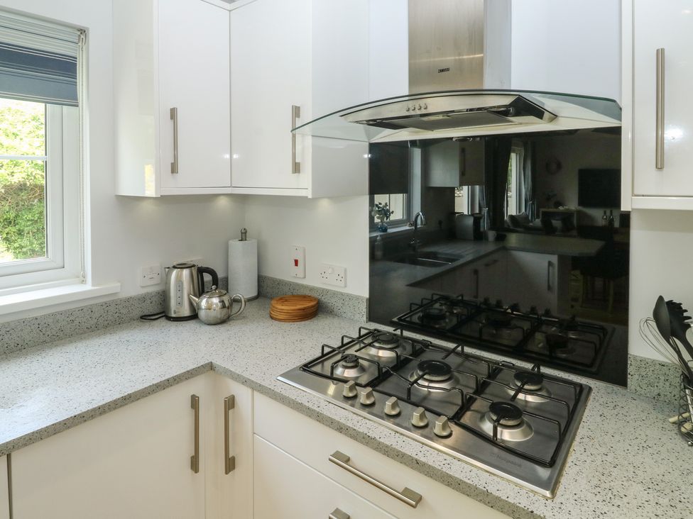 A kitchen with a stove and kettle at Glebe House in Bigbury