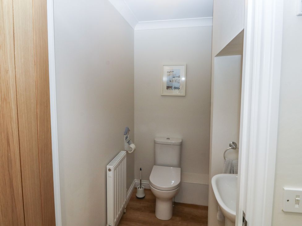 A bathroom with a toilet and wash basin at Glebe House Bigbury