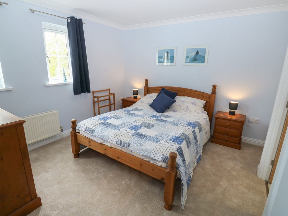 A bedroom with a bed and bedside tables at Glebe House in Bigbury