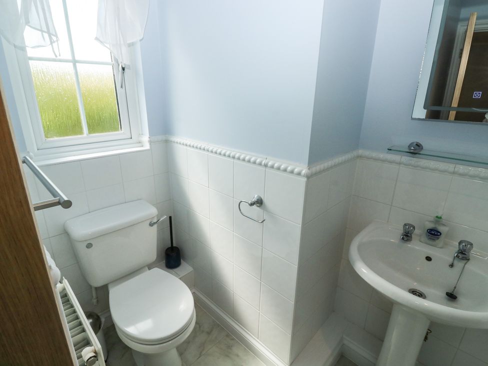 A bathroom with a toilet and a sink at Glebe House in Bigbury
