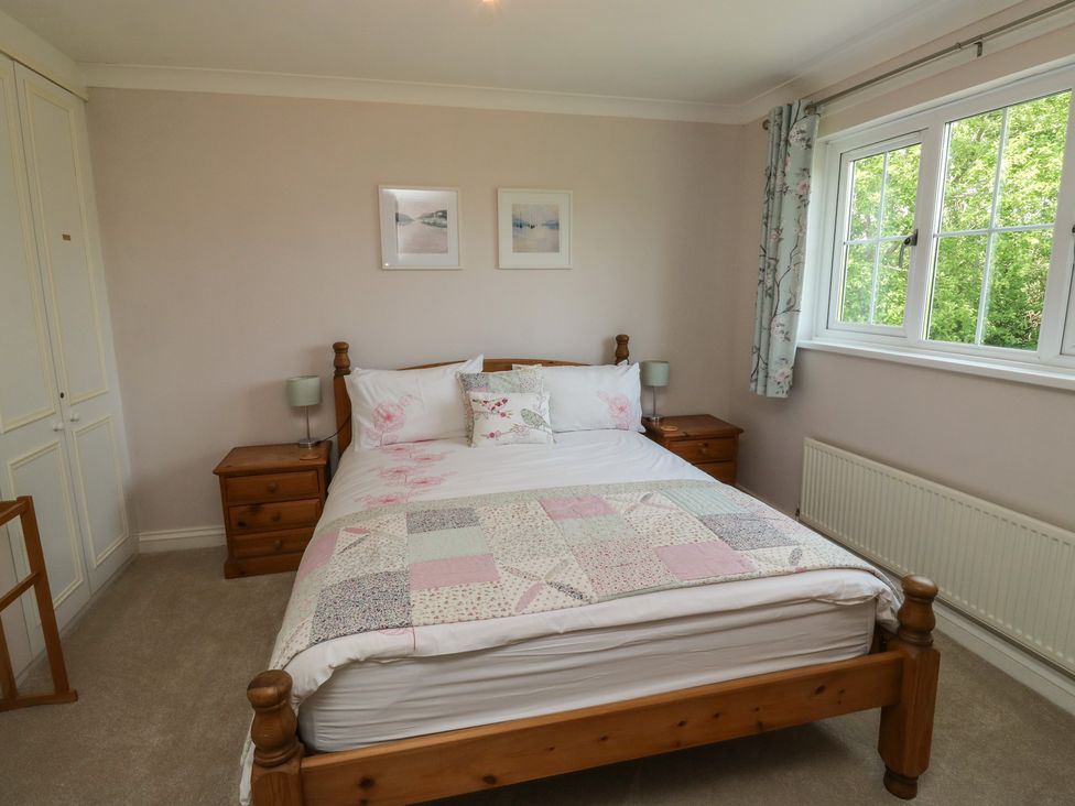 A bedroom with a bed and bedside tables at Glebe House in Bigbury
