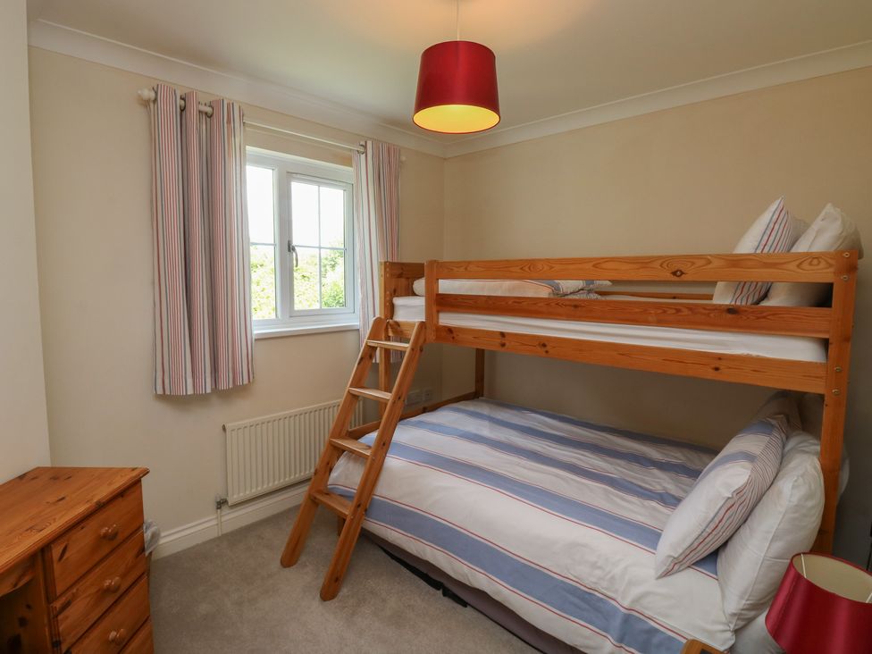 A bedroom with a bunk bed and a double bed at Glebe House Bigbury
