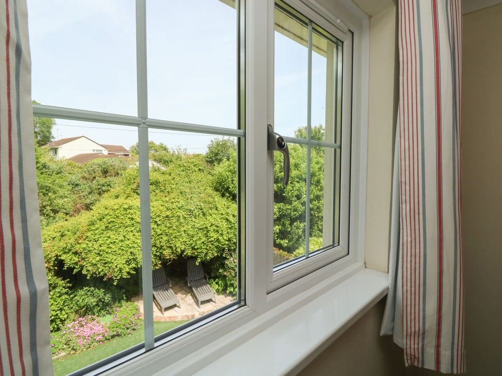 A window view of a garden with chairs at Glebe House Bigbury