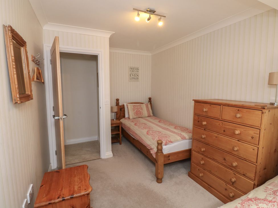 A bedroom with two single beds and a chest of drawers at Glebe House in Bigbury