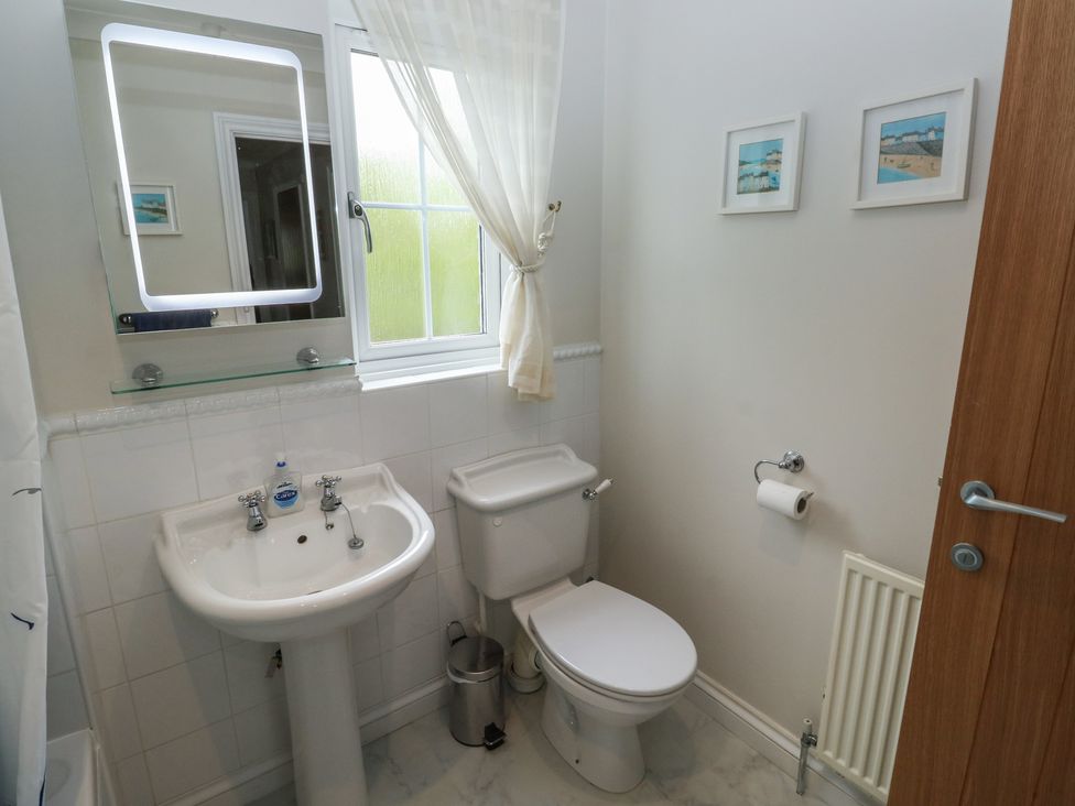 A bathroom with a sink and toilet at Glebe House in Bigbury