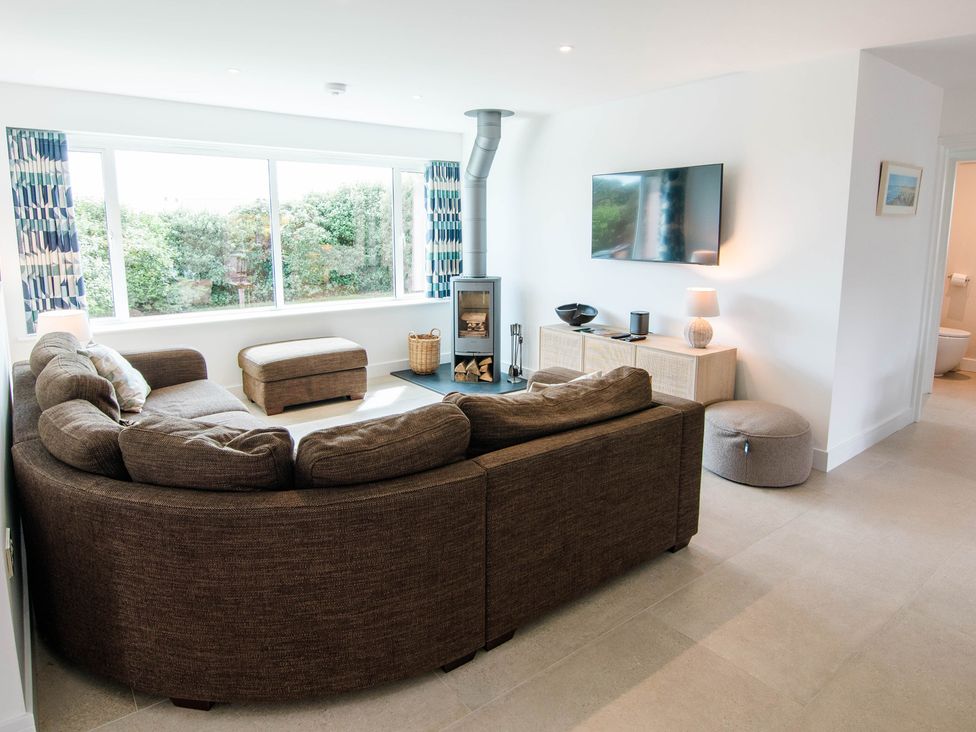 A living room with a sofa and TV at Lanesend in St Agnes