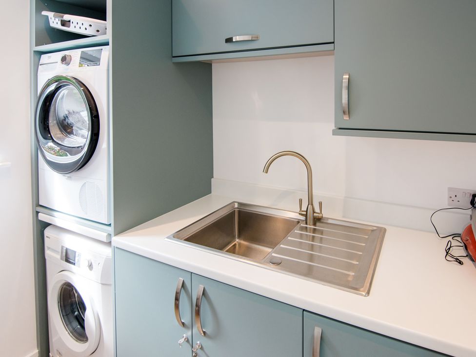 A laundry room with washing machine and dryer at Lanesend in St Agnes