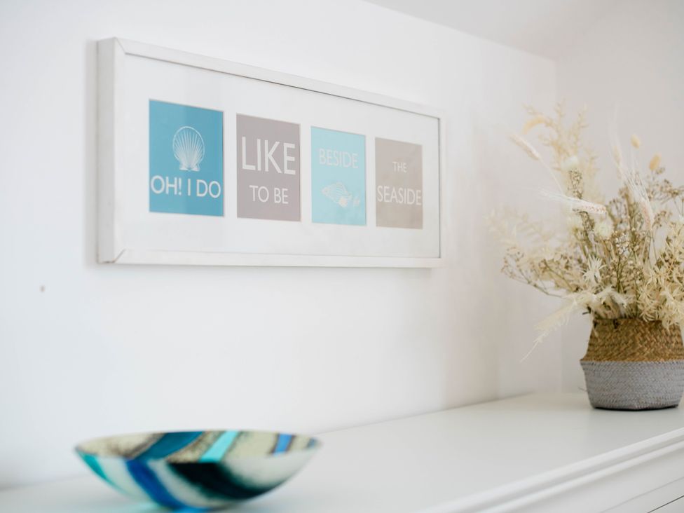 A decorative display with a picture frame and a vase at Lanesend in St Agnes