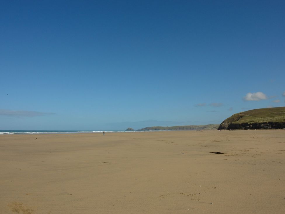 A beach with sand and hills at Lanesend in St Agnes