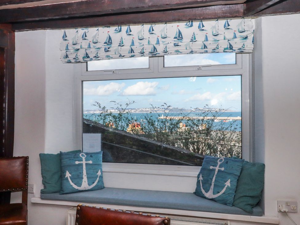 A viewing area with a window and cushions at Blue Horizon in Brixham