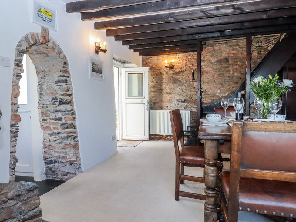 A dining room with a table and chairs at Blue Horizon in Brixham