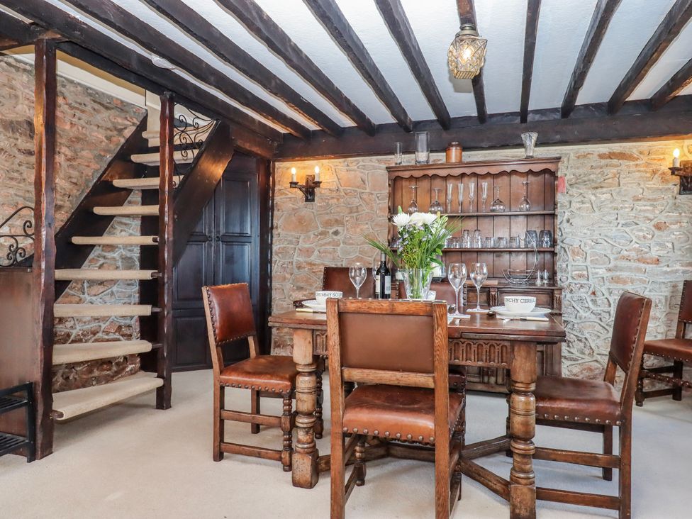 A dining room with a table and chairs at Blue Horizon in Brixham