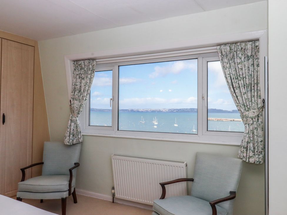 A bedroom with a view of the sea at Blue Horizon in Brixham
