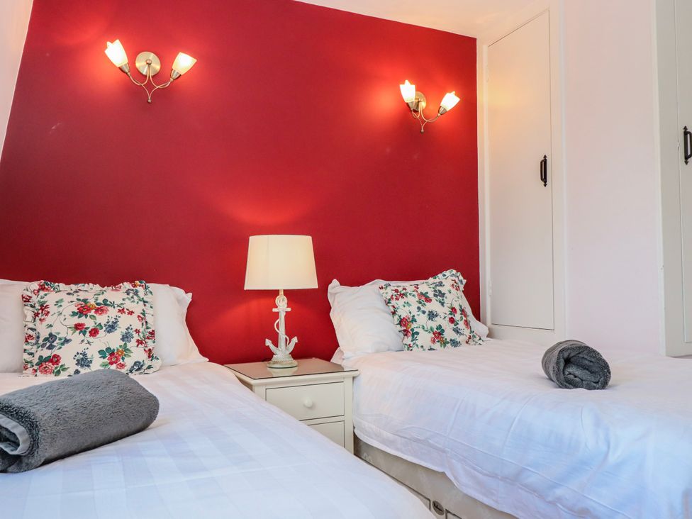 A bedroom with twin beds and a bedside table at Blue Horizon in Brixham