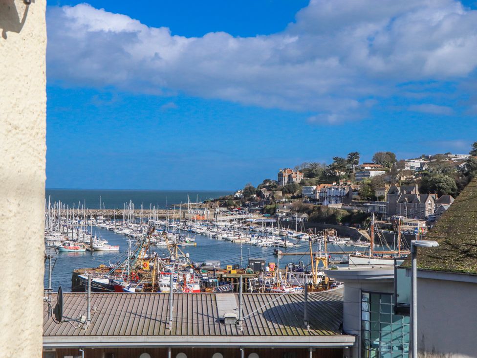 A view of a marina with boats and buildings at Blue Horizon in Brixham