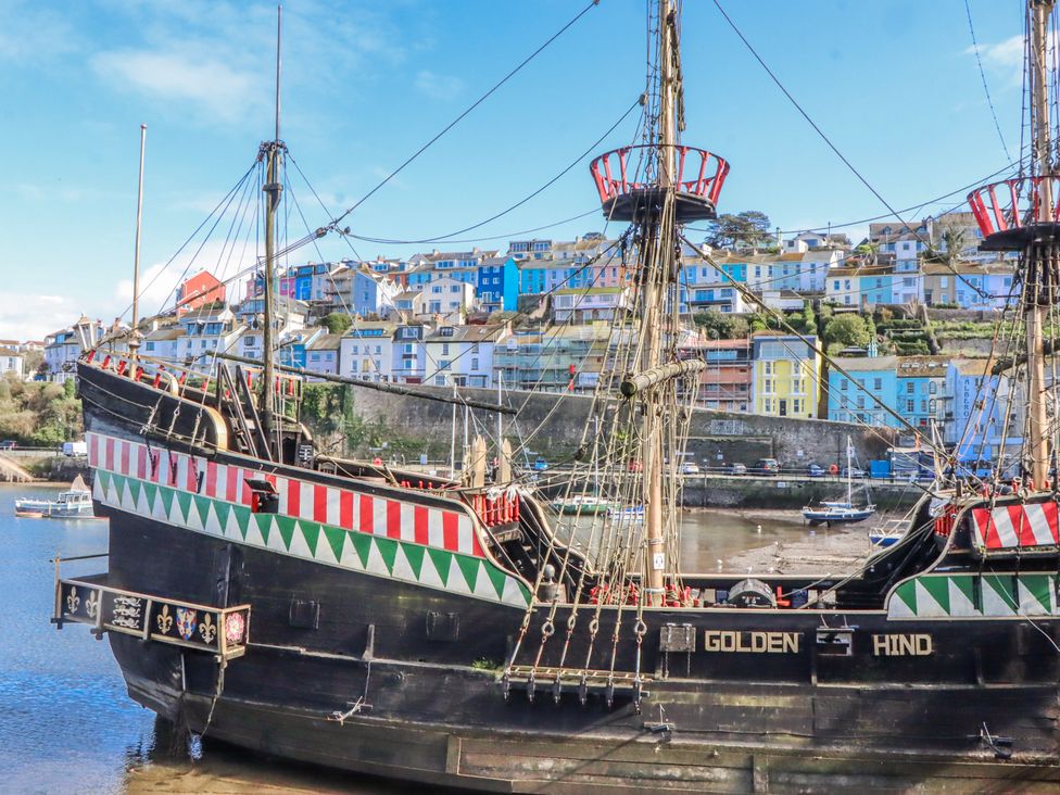 A ship in a harbor with buildings overlooking the water at Blue Horizon in Brixham