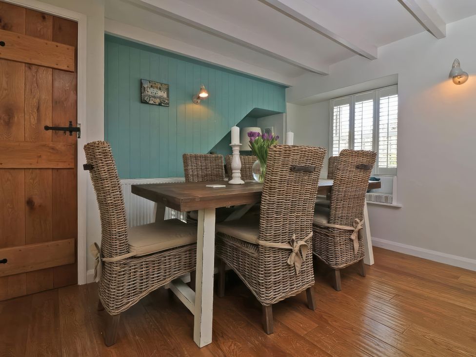 A dining room with a table and chairs at Trelan in Mevagissey