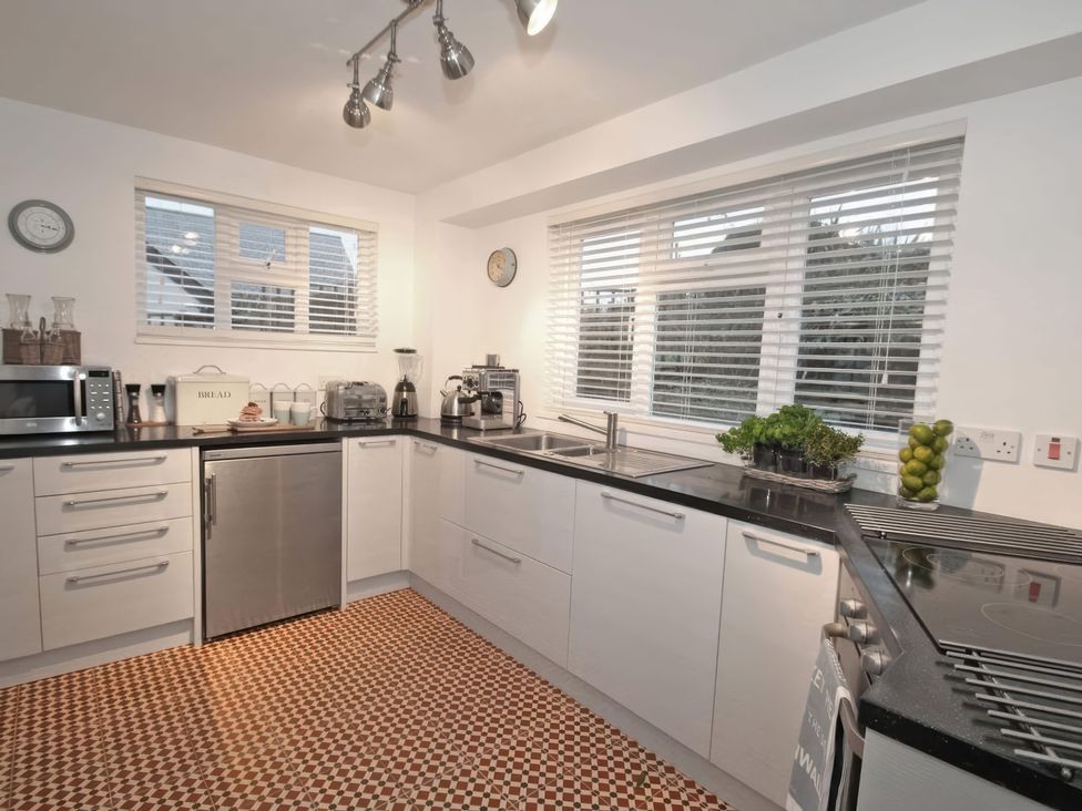 A kitchen with modern appliances and a stove at Trelan in Mevagissey