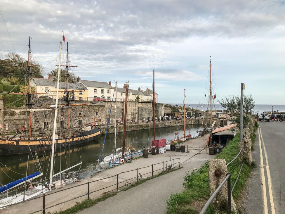 A harbor with boats and buildings near water at Trelan in Mevagissey