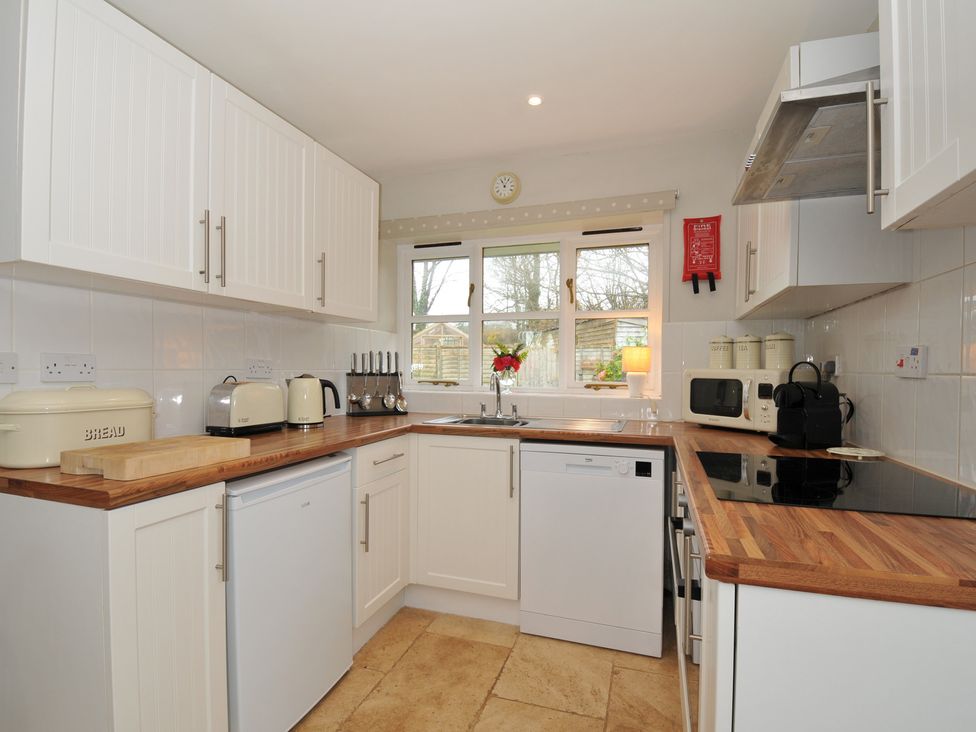 A kitchen with cabinets and appliances at Stocks Barn in Looe