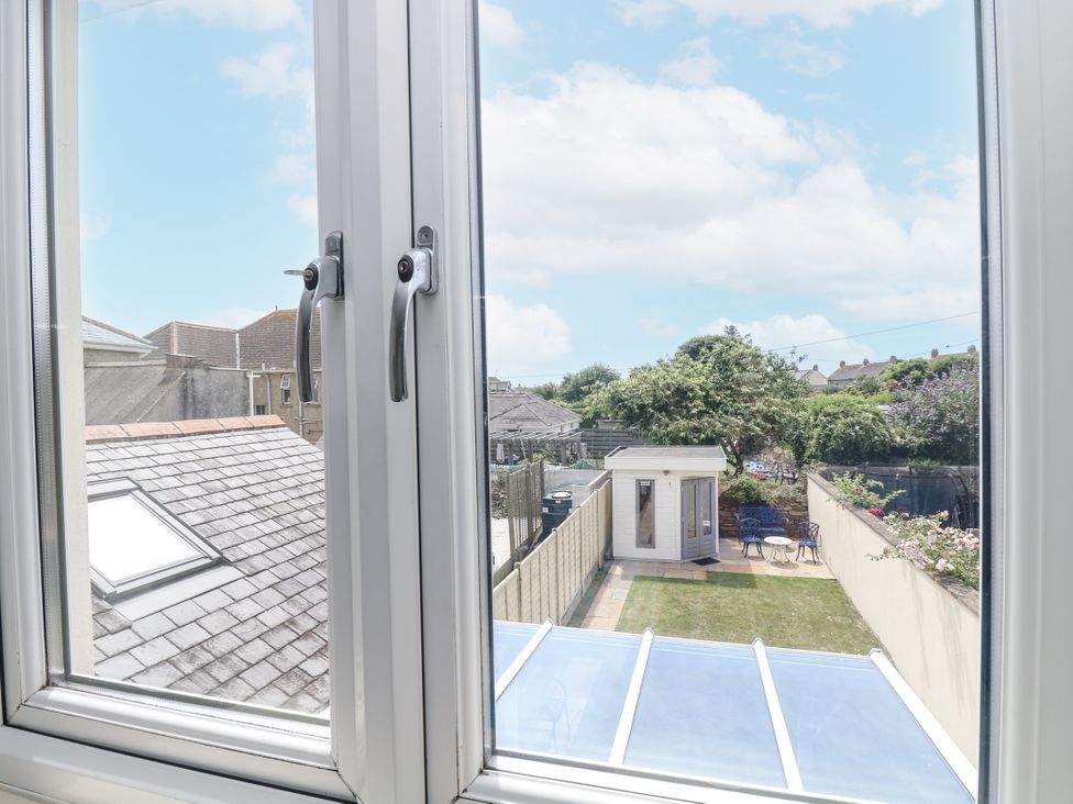A view from a window showing a garden and shed at Ridgeback House in Mullion