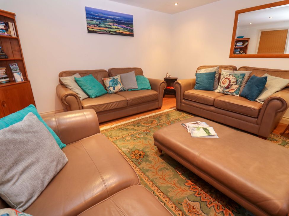 A living room with sofas and a coffee table at Ridgeback House in Mullion