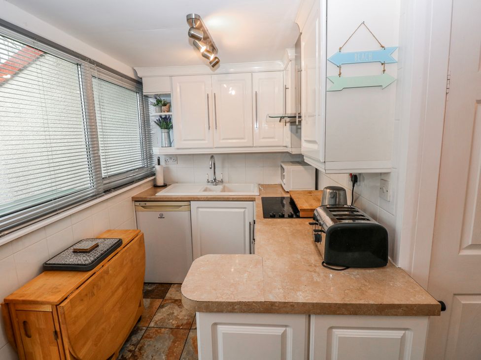 A kitchen with sink and appliances at Trelessy Lodge Llanteg near Amroth