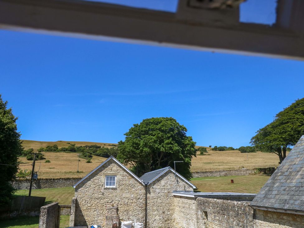 A view of buildings and fields under a clear sky at The Stable Cottage in Wroxall
