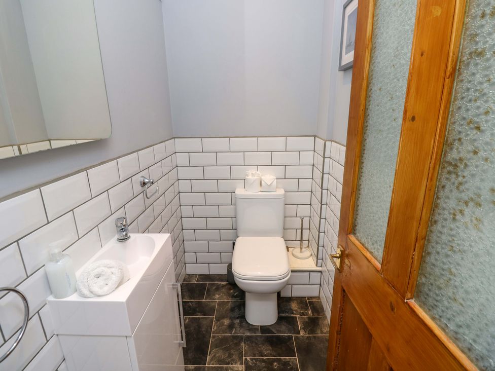 A bathroom with a toilet and sink at The Stable Cottage in Wroxall