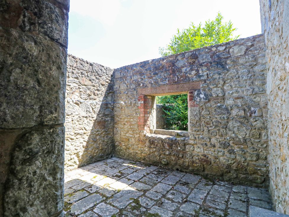 An indoor space with stone walls and a window at The Stable Cottage in Wroxall