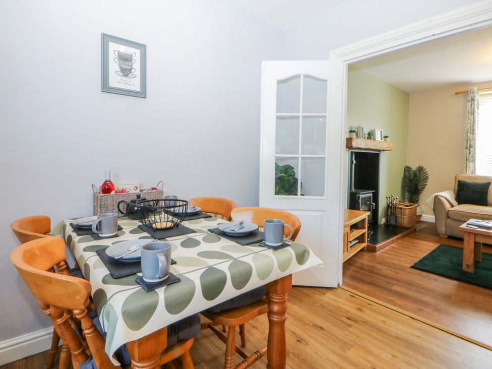 A dining room with a table and chairs at Bythynnod Newydd in Trefor near Nefyn