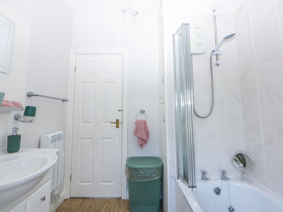 A bathroom with a sink, shower, and bathtub at Bythynnod Newydd Trefor near Nefyn
