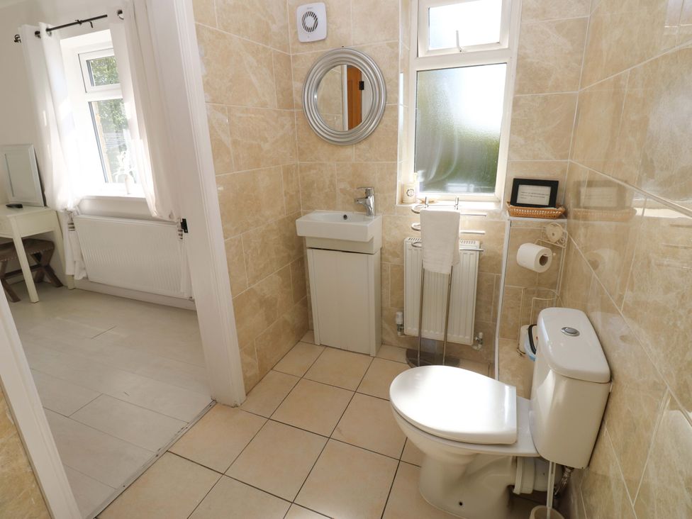 A bathroom with a sink and toilet at Blacksmiths Cottage in Shilbottle