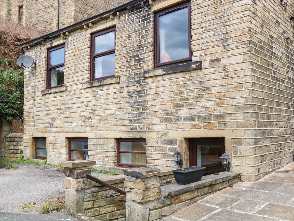 An outdoor area with stone walls and windows at Half Under 