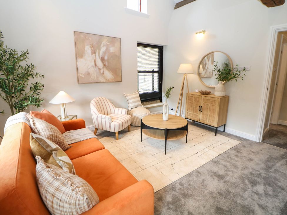A living room with a sofa and armchair at Half Under