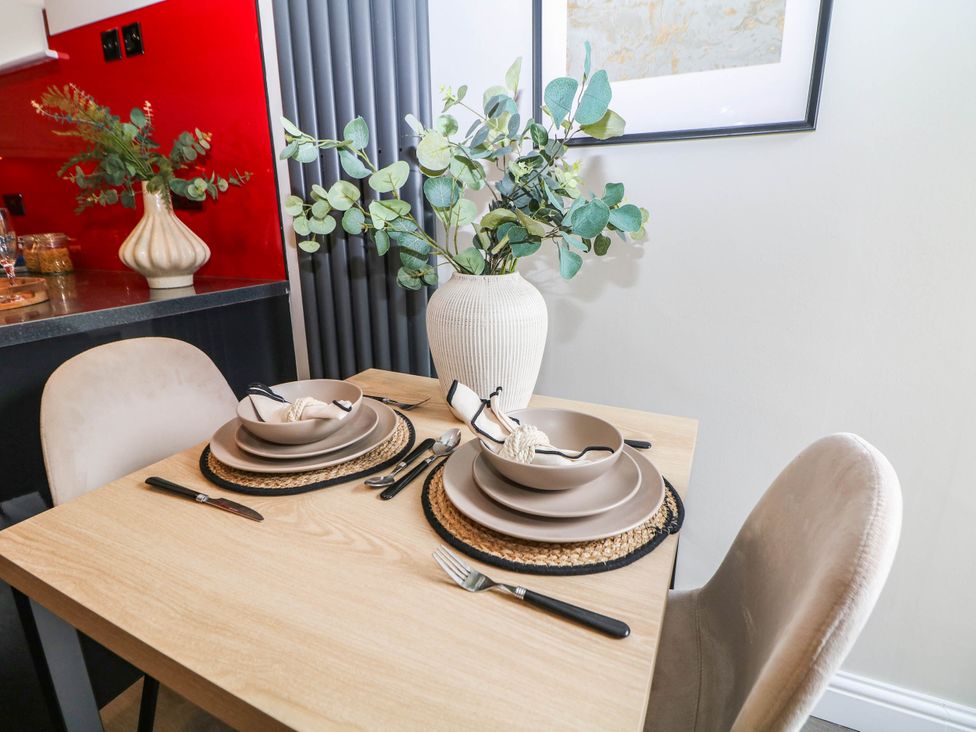 A dining table set with plates and cutlery at Half Under