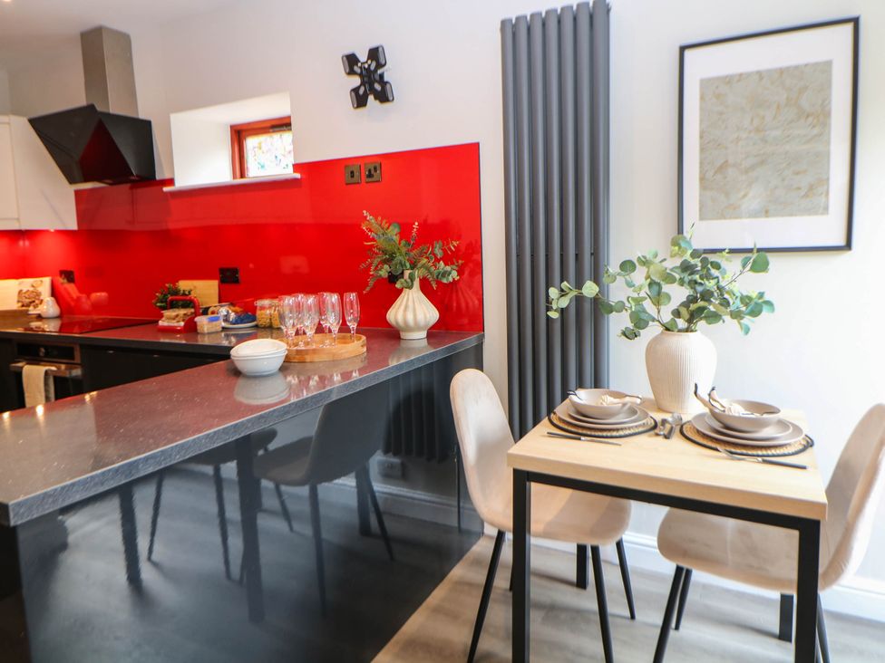 A kitchen with a dining area featuring a table and chairs at Half Under 