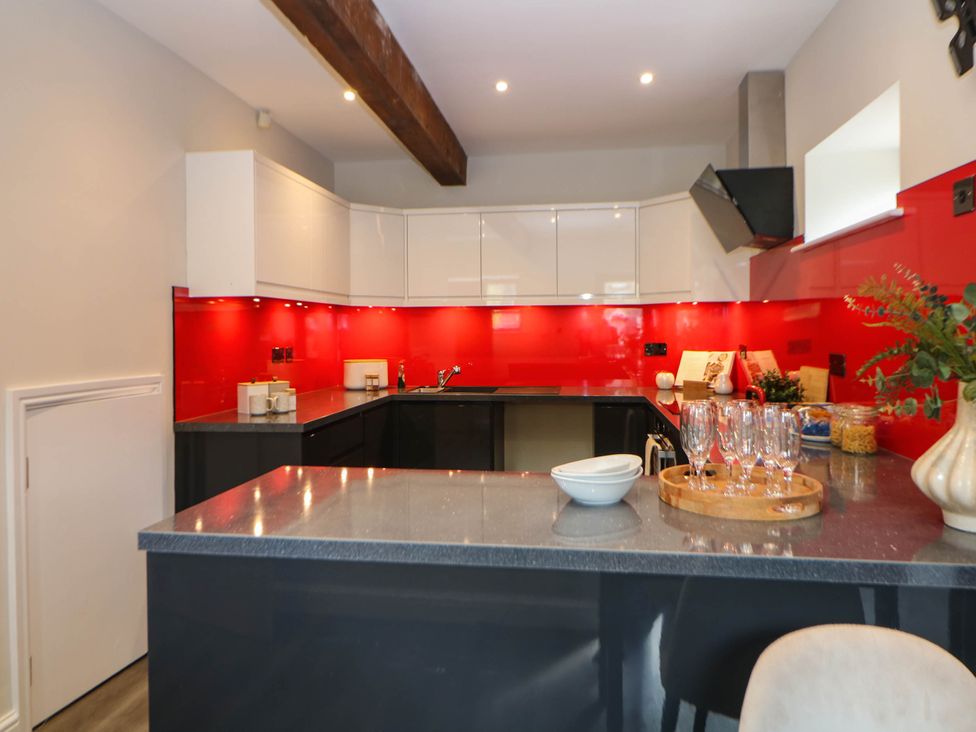 A kitchen with countertops and appliances at Half Under