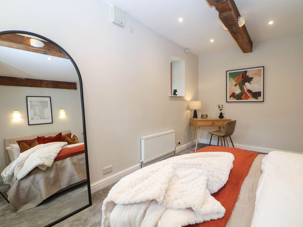 A bedroom with a bed and a desk at Half Under
