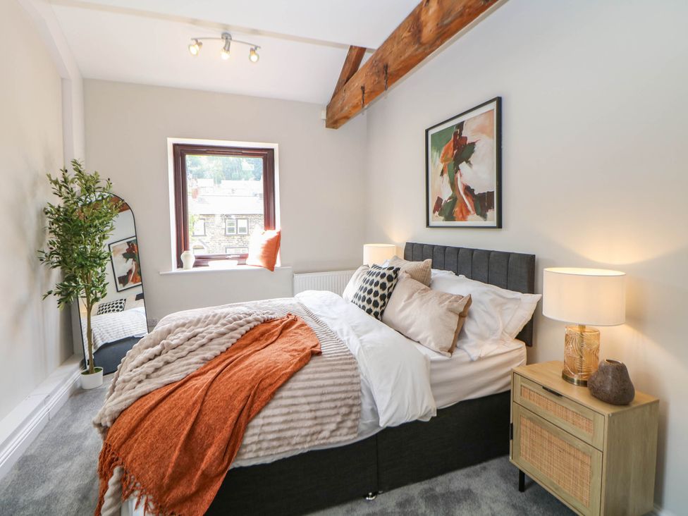 A bedroom with a bed and a decorative plant at Half Under 