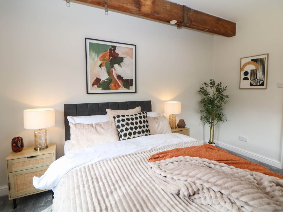 A bedroom with a bed and bedside table at Half Under