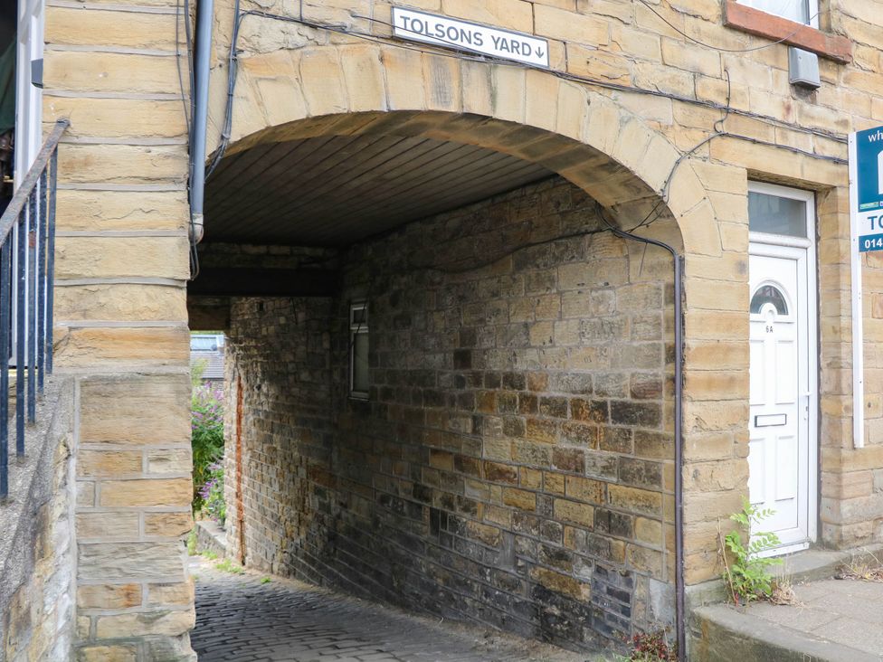 An archway leading to a cobblestone path at Half Under 