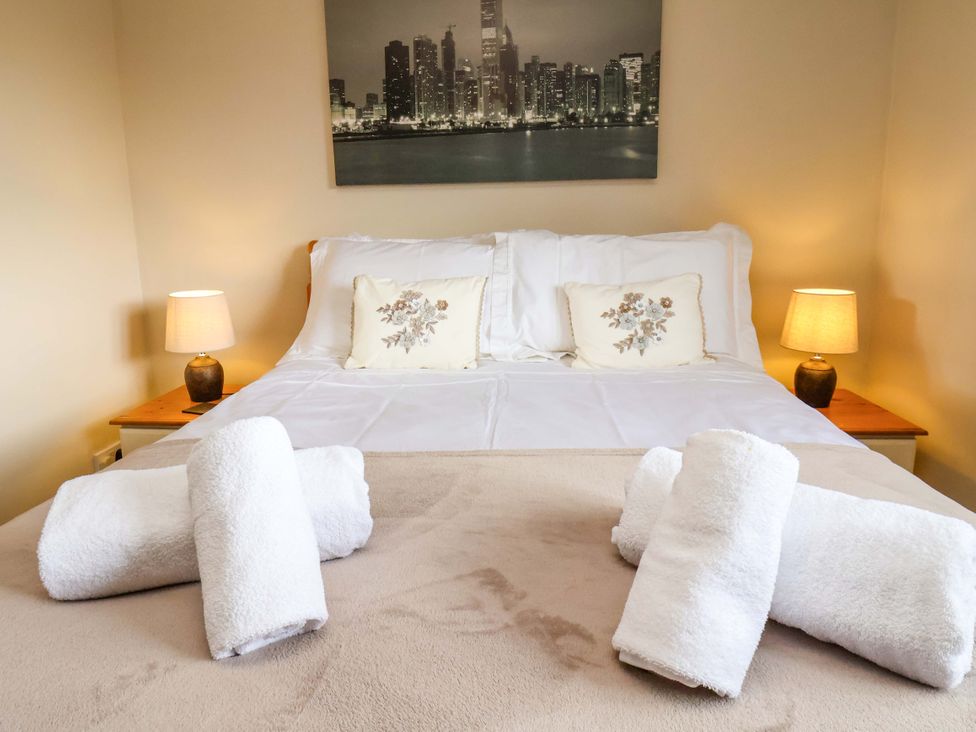 A bedroom with a bed and bedside lamps at Eskview Cottage in Ruswarp near Whitby